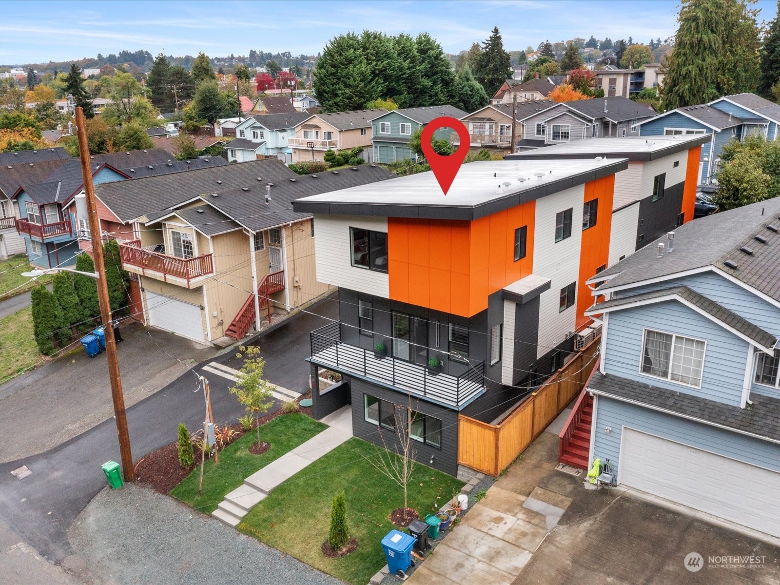 an aerial view of a house with garden space and street view