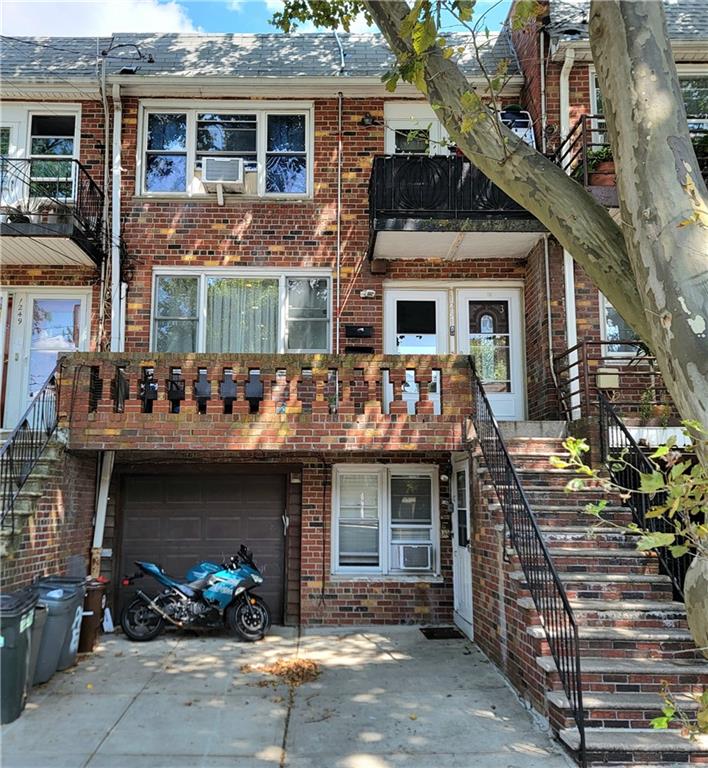 a front view of a house with car parked