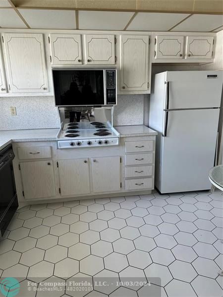 a kitchen with a stove and a refrigerator