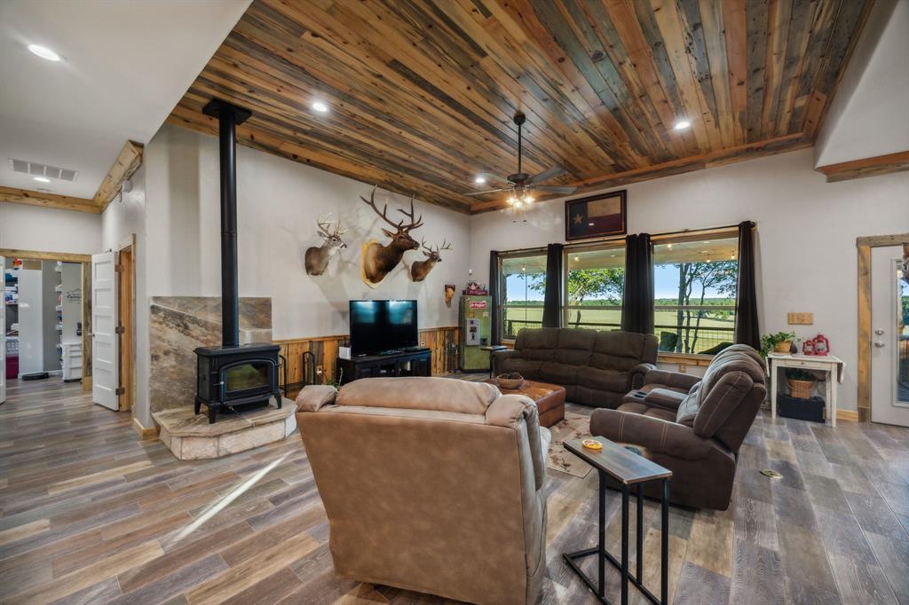 a living room with furniture a wooden floor and next to a window