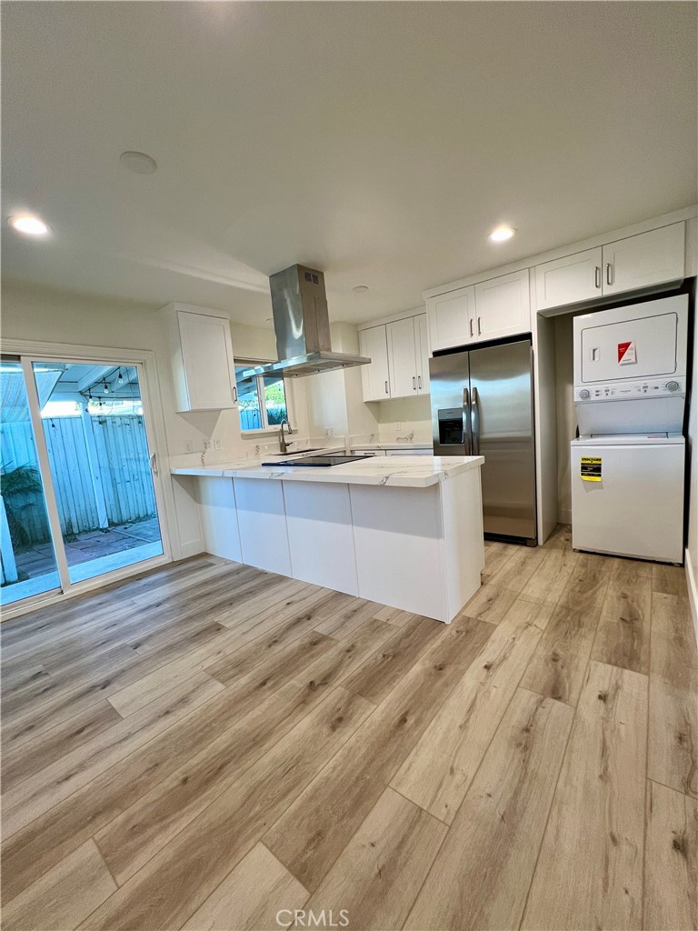 a kitchen with cabinets and wooden floor