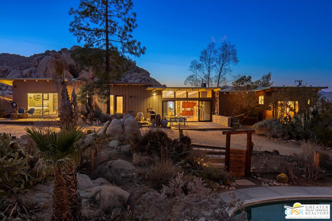 a view of a house with a yard and tree s