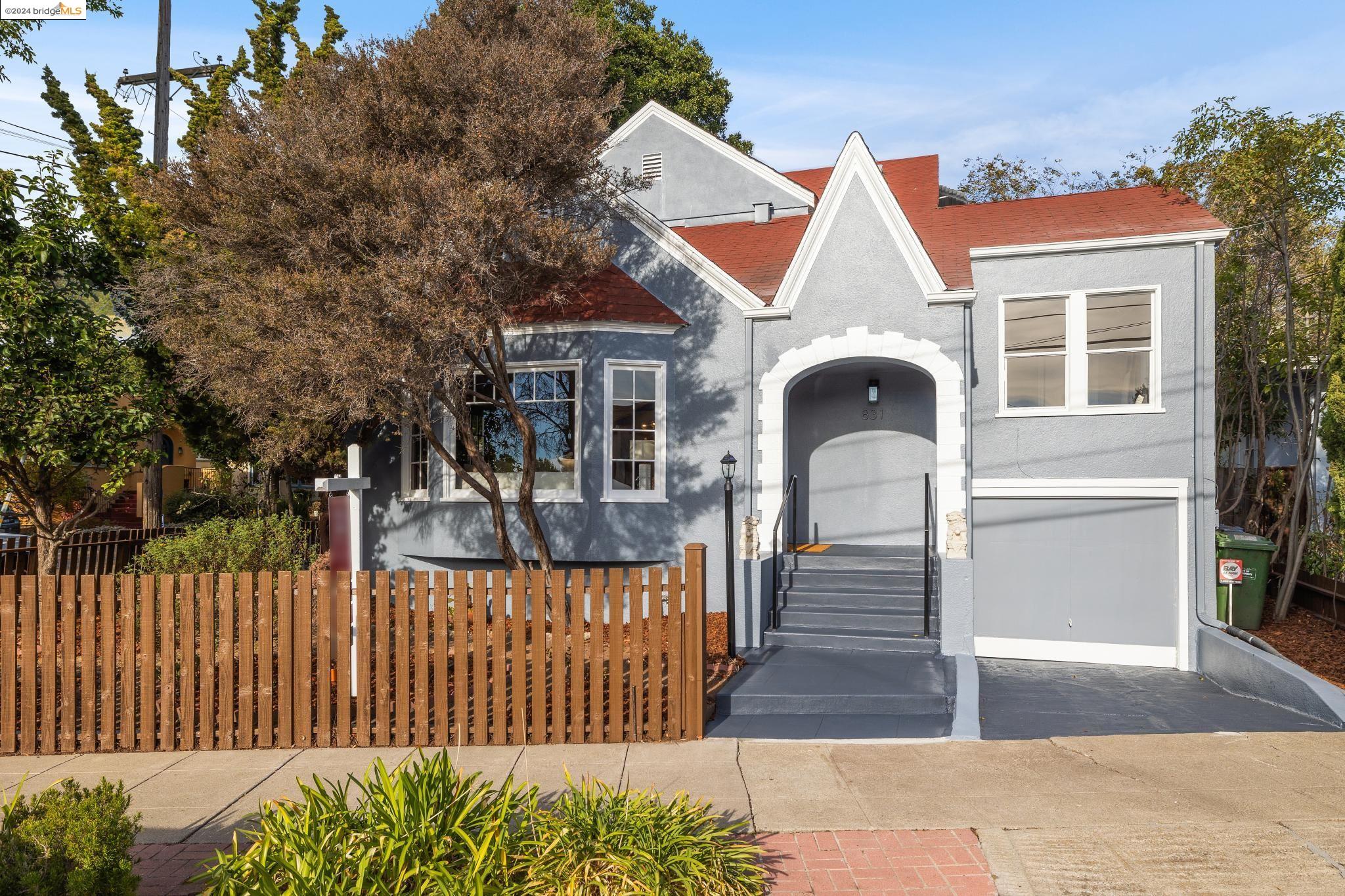 a front view of a house with wooden fence