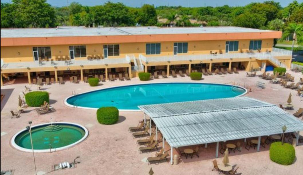 a front view of a house with swimming pool and patio