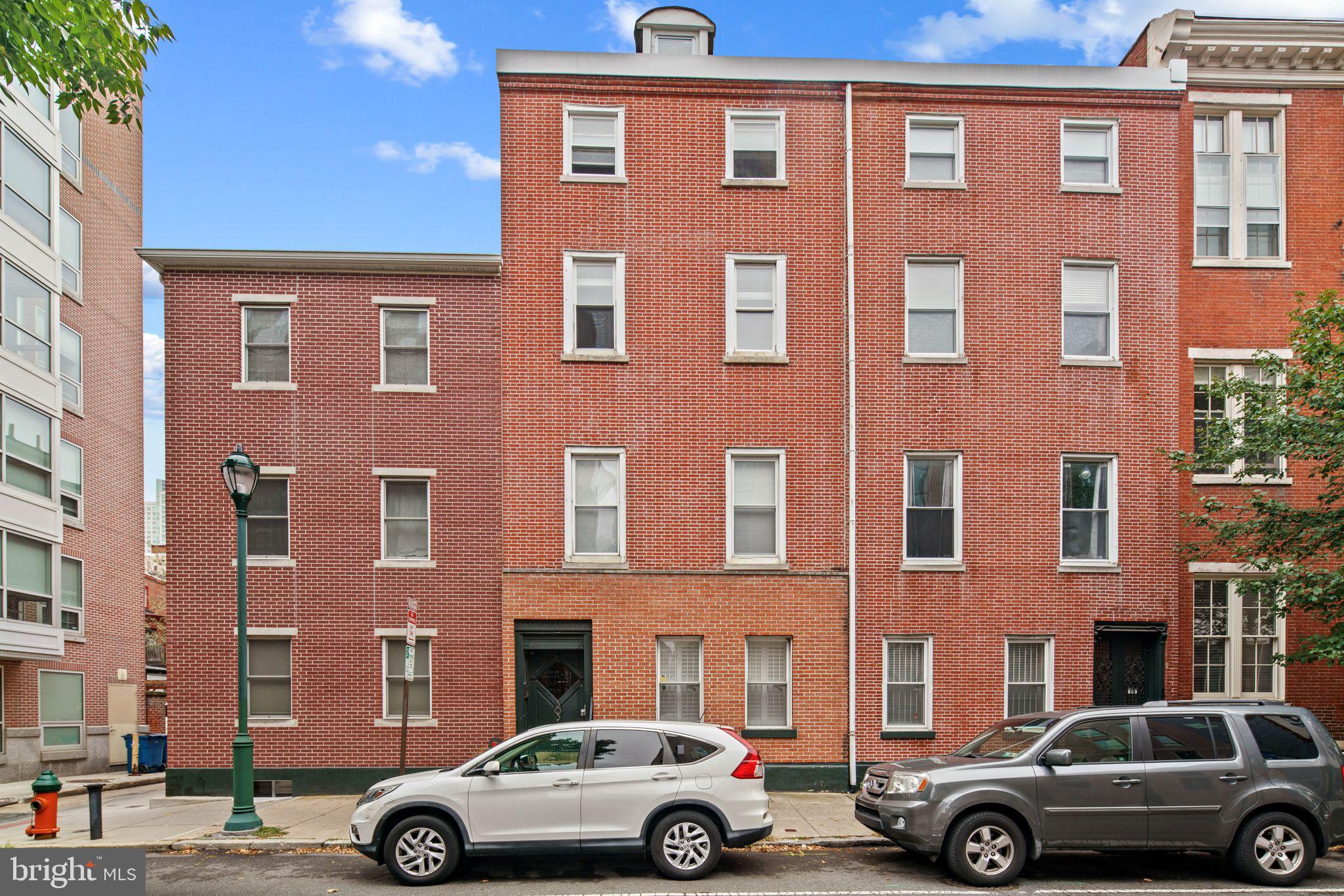 a front view of a building with parking space