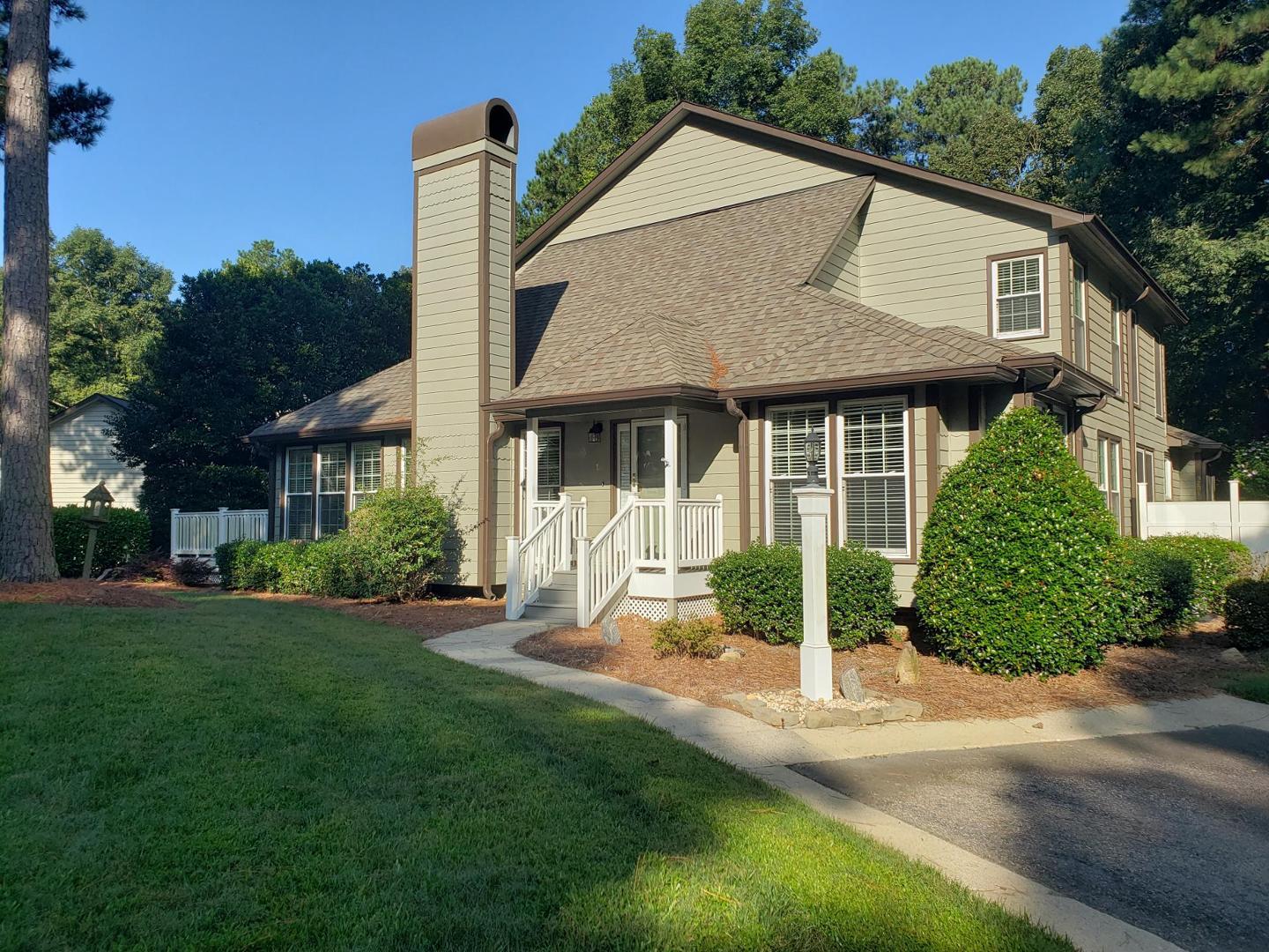 a view of a house with a yard and plants