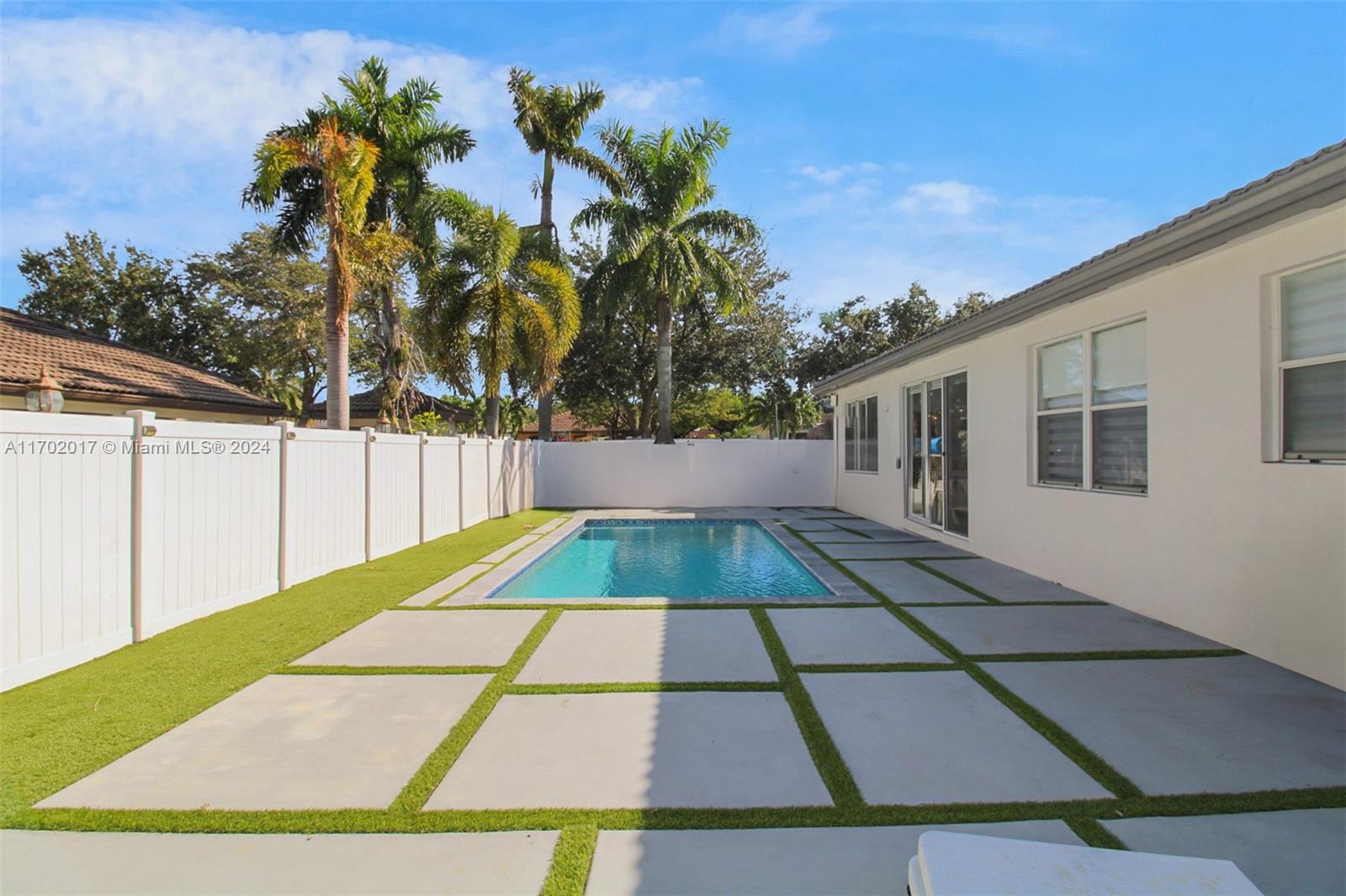 a view of backyard with a patio