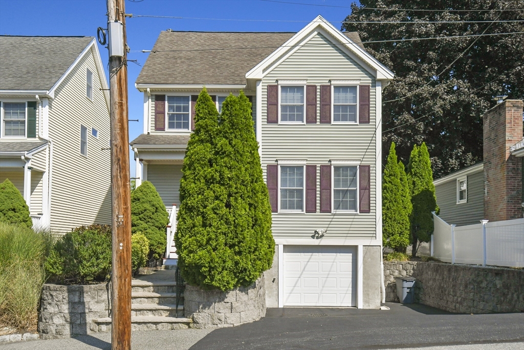 a front view of a house with a yard and garage