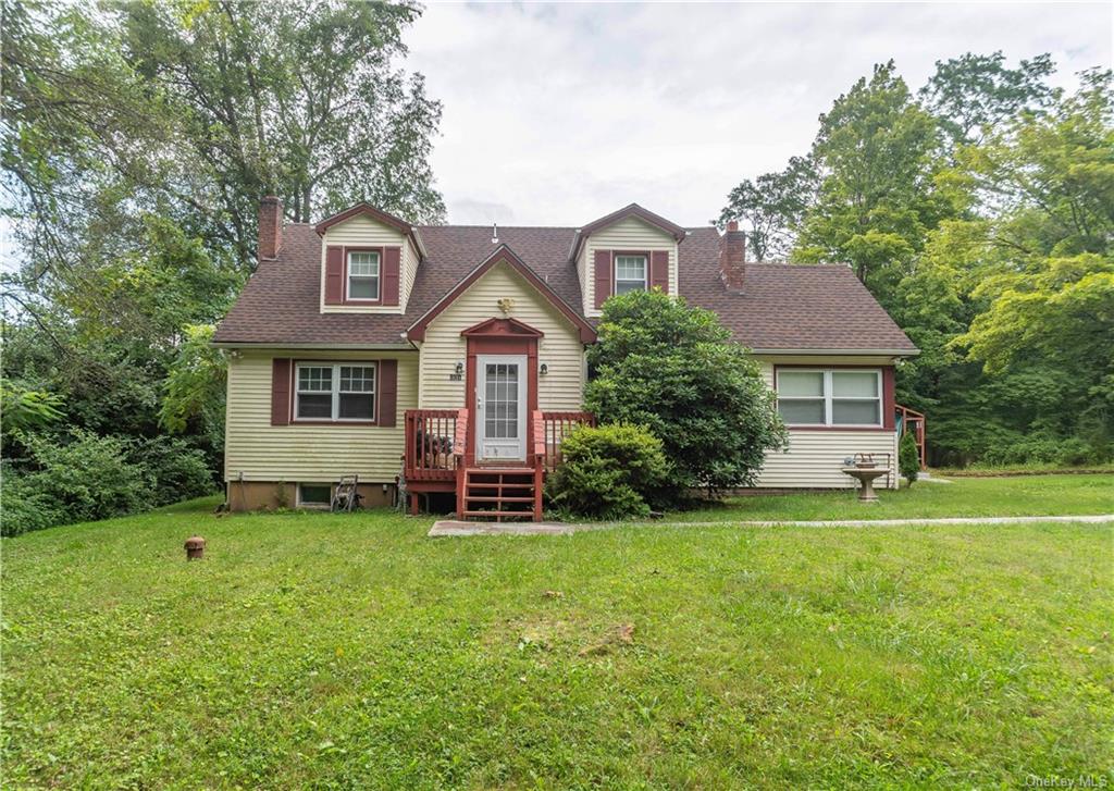 Cape cod home with a front lawn