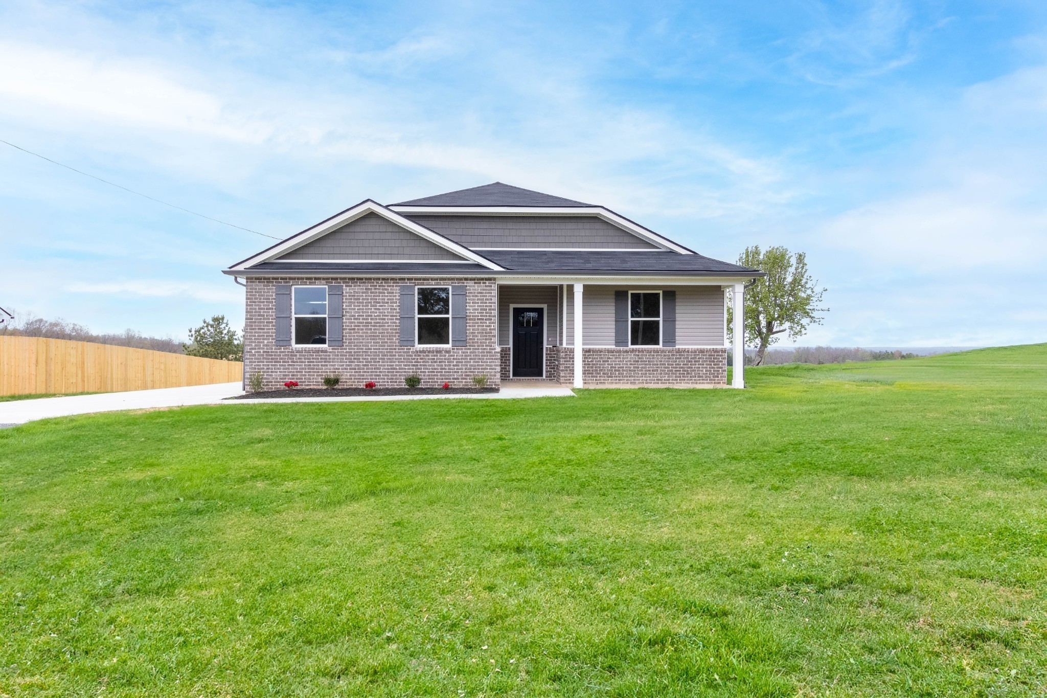 a front view of house with yard and green space