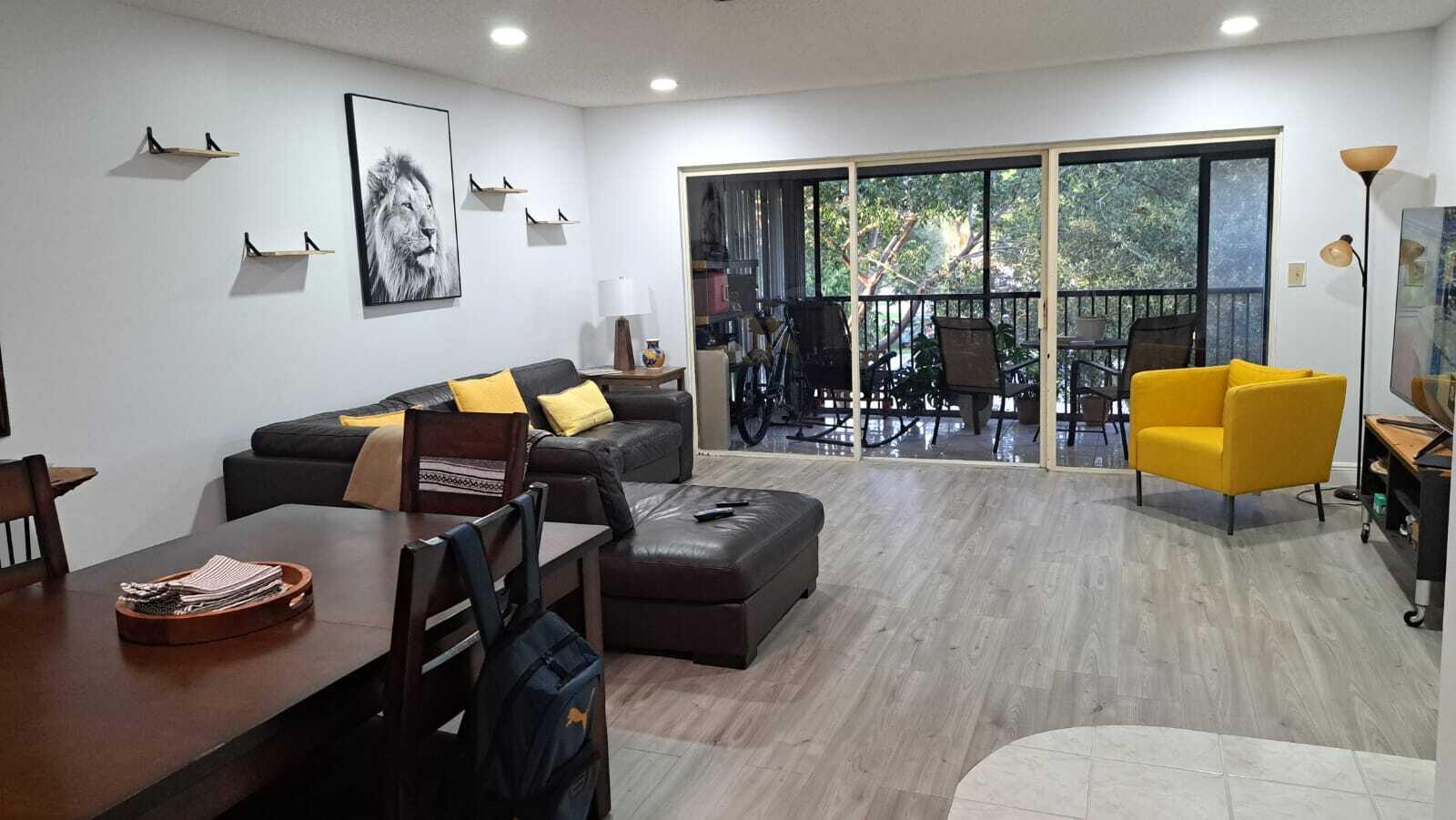 a living room with furniture and wooden floor