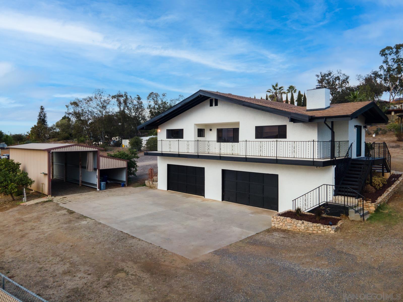 a view of a house with a yard and garage