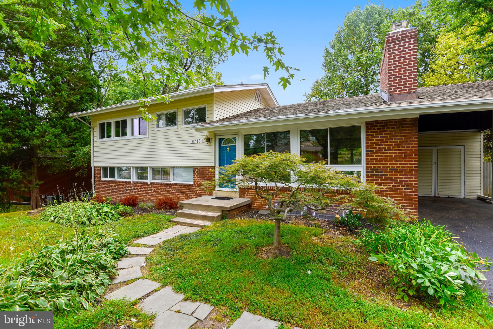 a front view of a house with a yard and porch