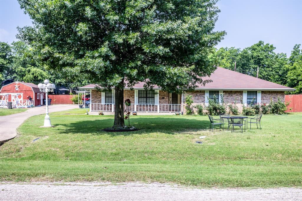 a front view of a house with a yard table and chairs