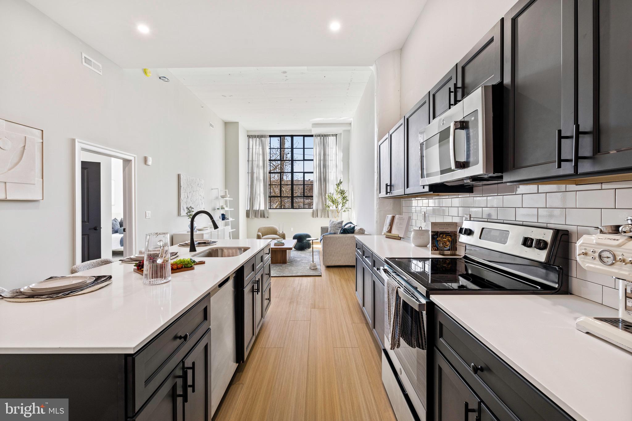 a kitchen with stainless steel appliances a sink stove and cabinets