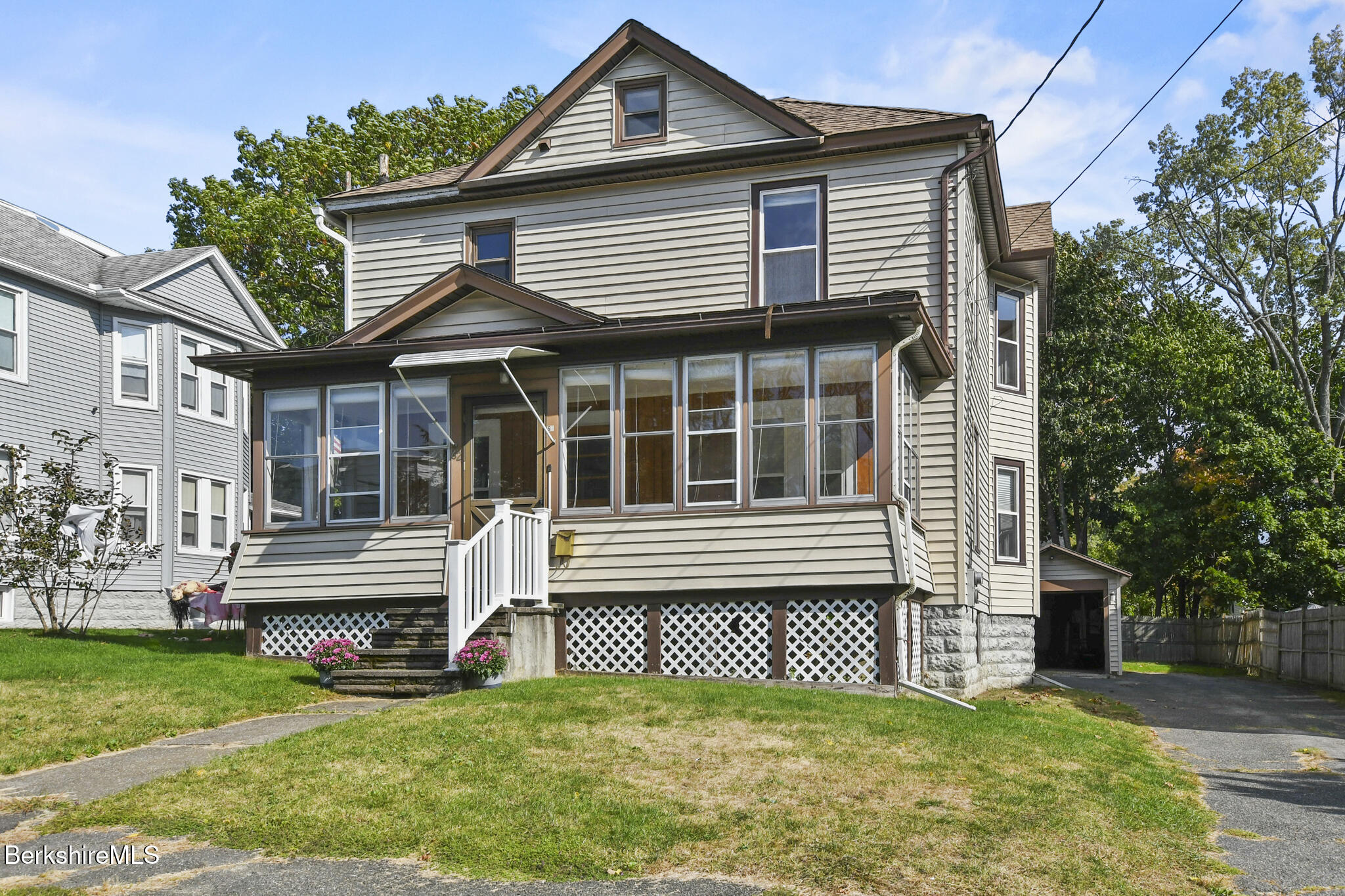 a front view of a house with a garden