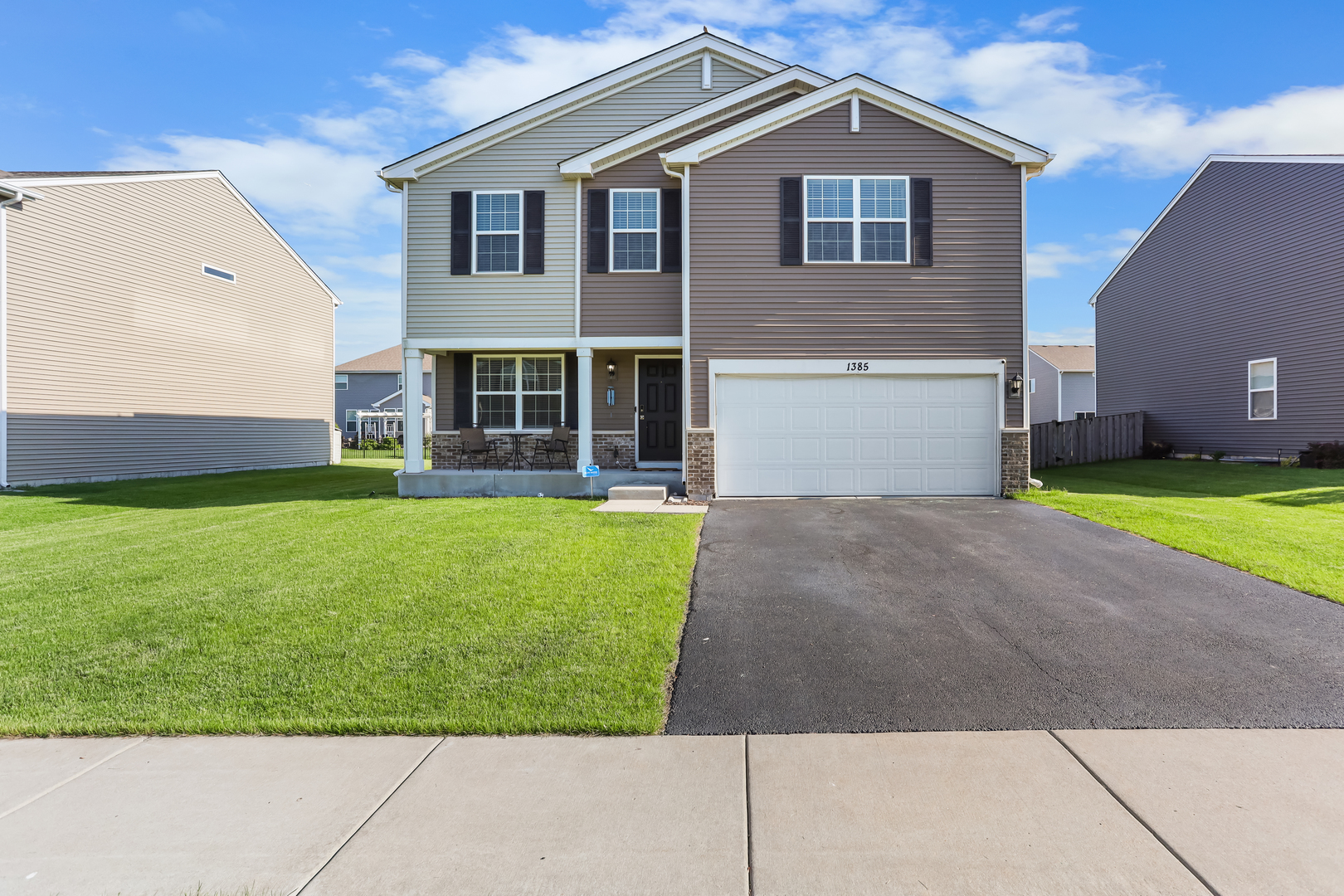 a view of a house with a yard and sitting area