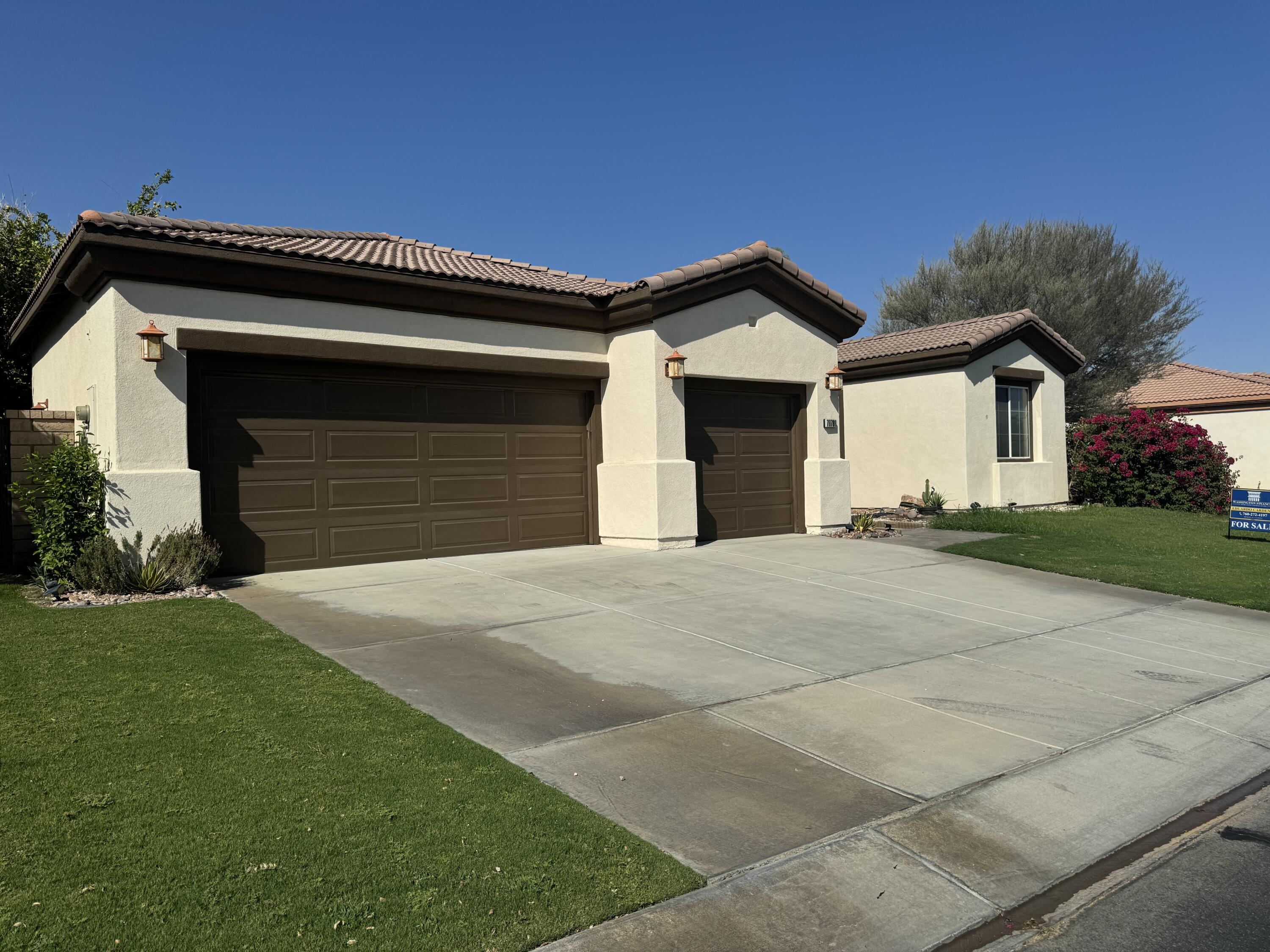 a front view of a house with a yard and garage