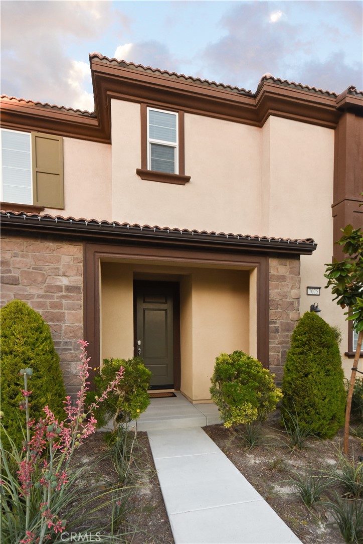 a front view of a house with a garden