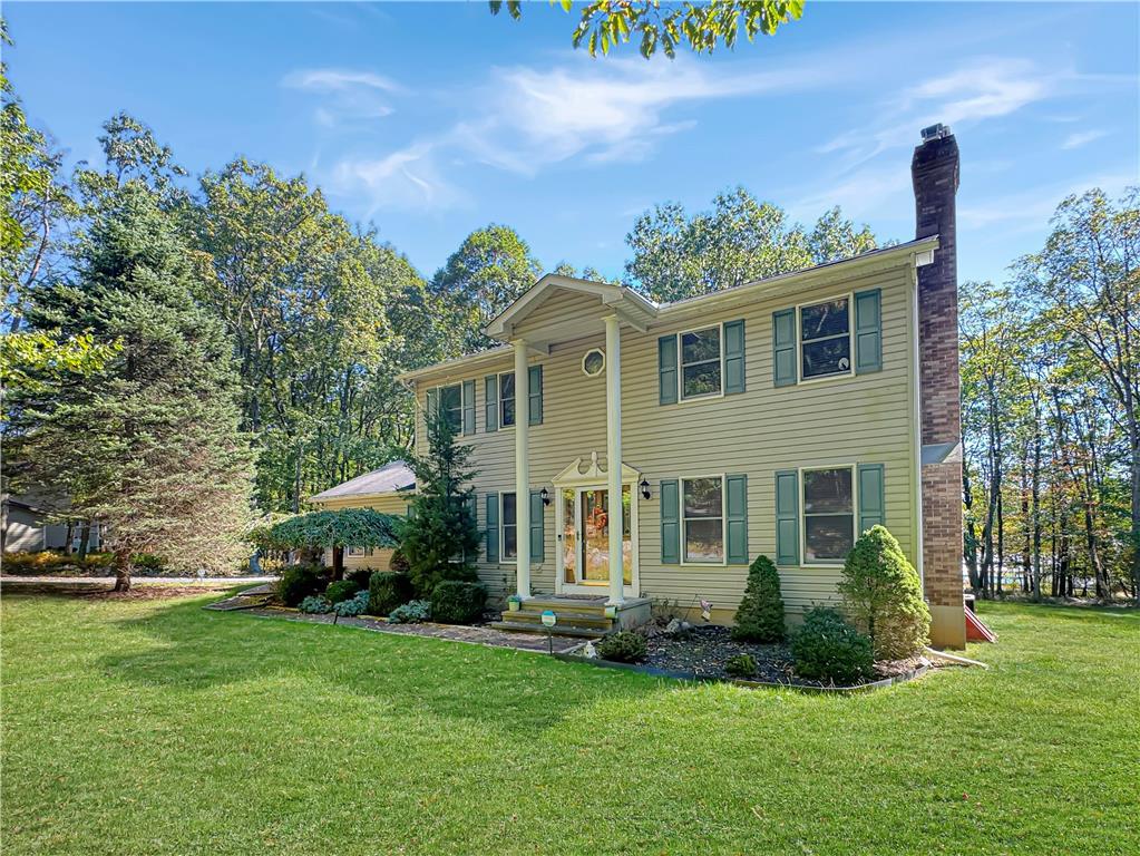 a front view of a house with a garden