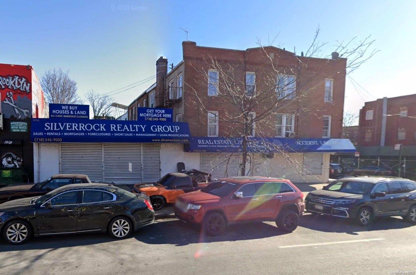 a view of a cars park in front of a building