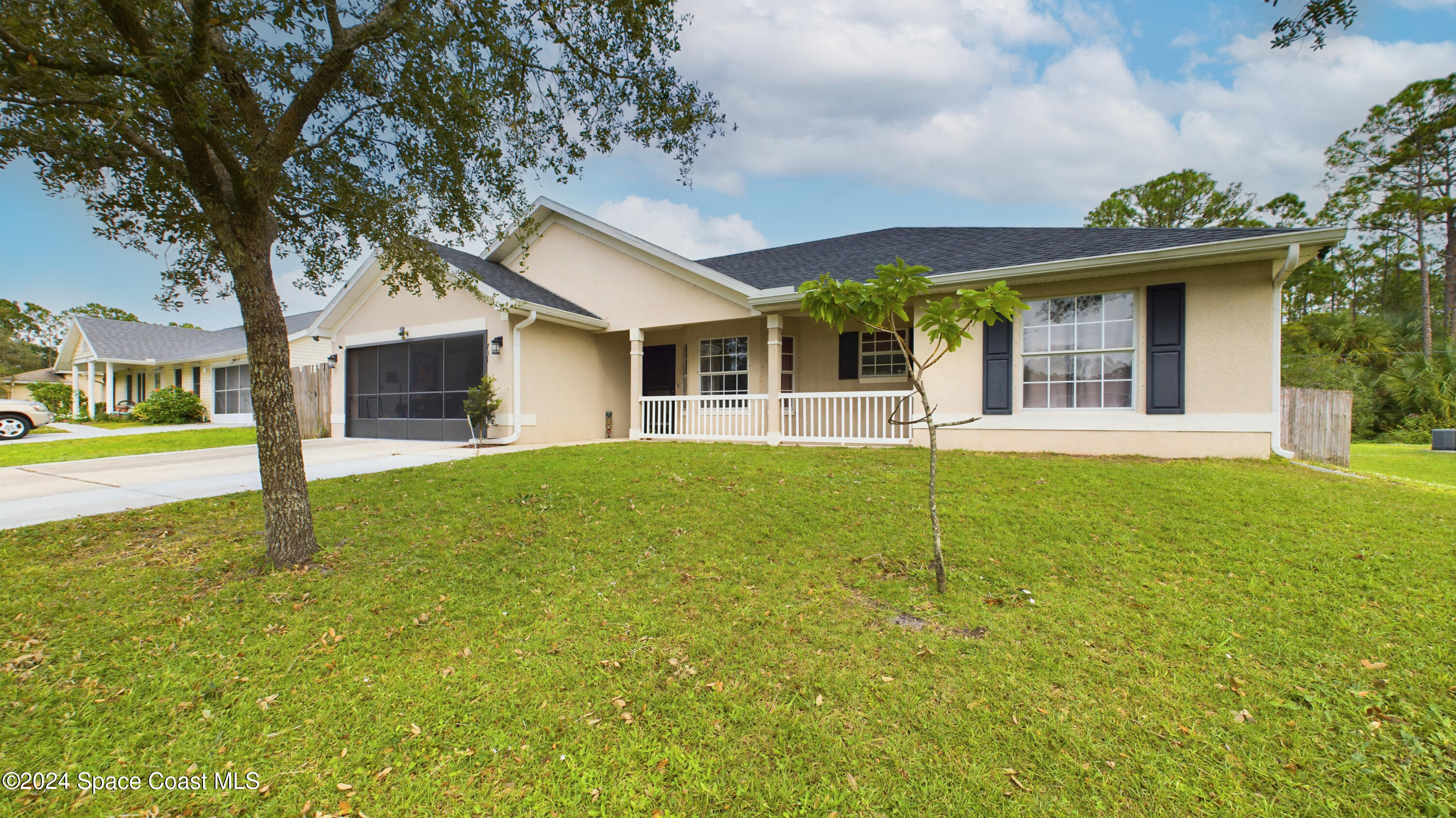 a front view of house with yard and green space