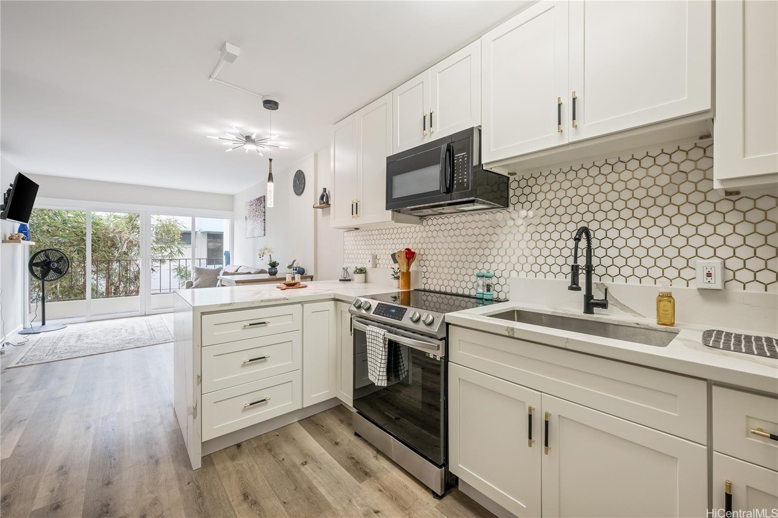 a kitchen with white cabinets stainless steel appliances and sink