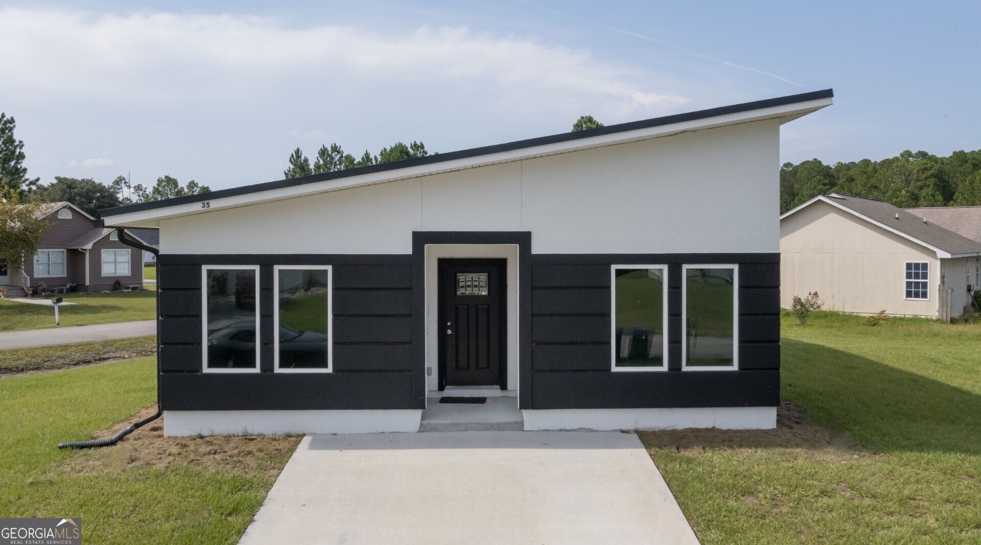 a front view of a house with a yard