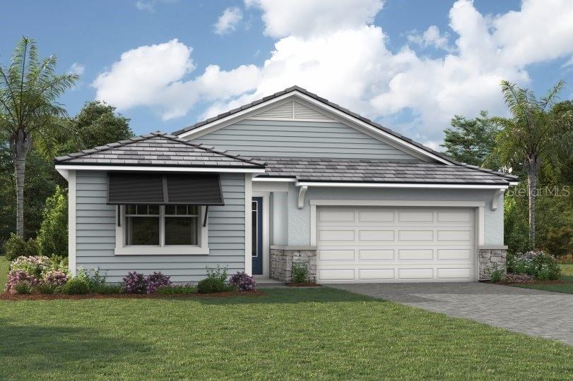 a front view of a house with a garden and garage