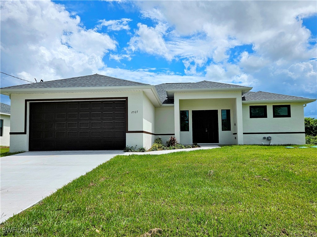 a front view of a house with a yard and garage