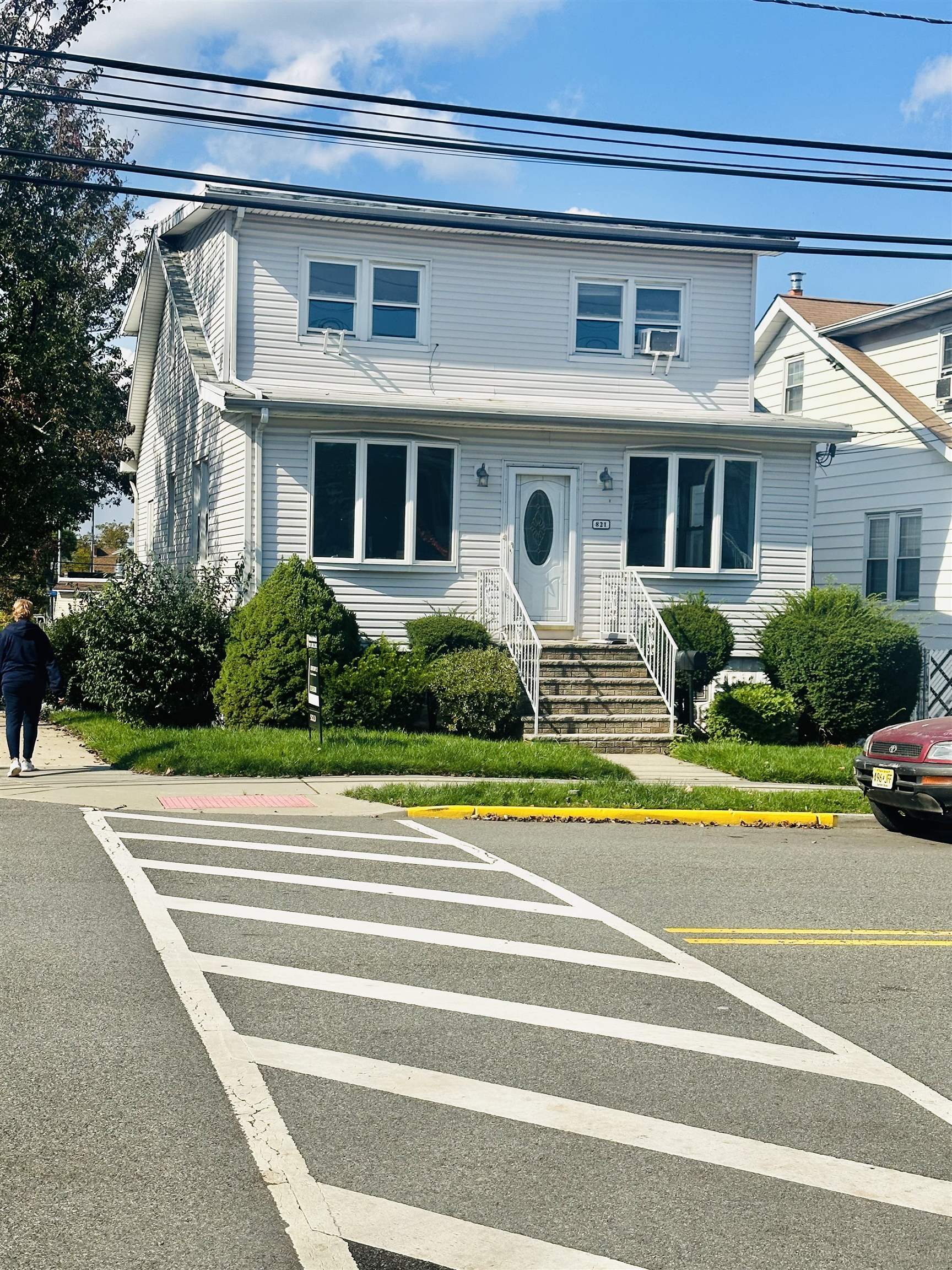 a front view of a house with a yard and plants