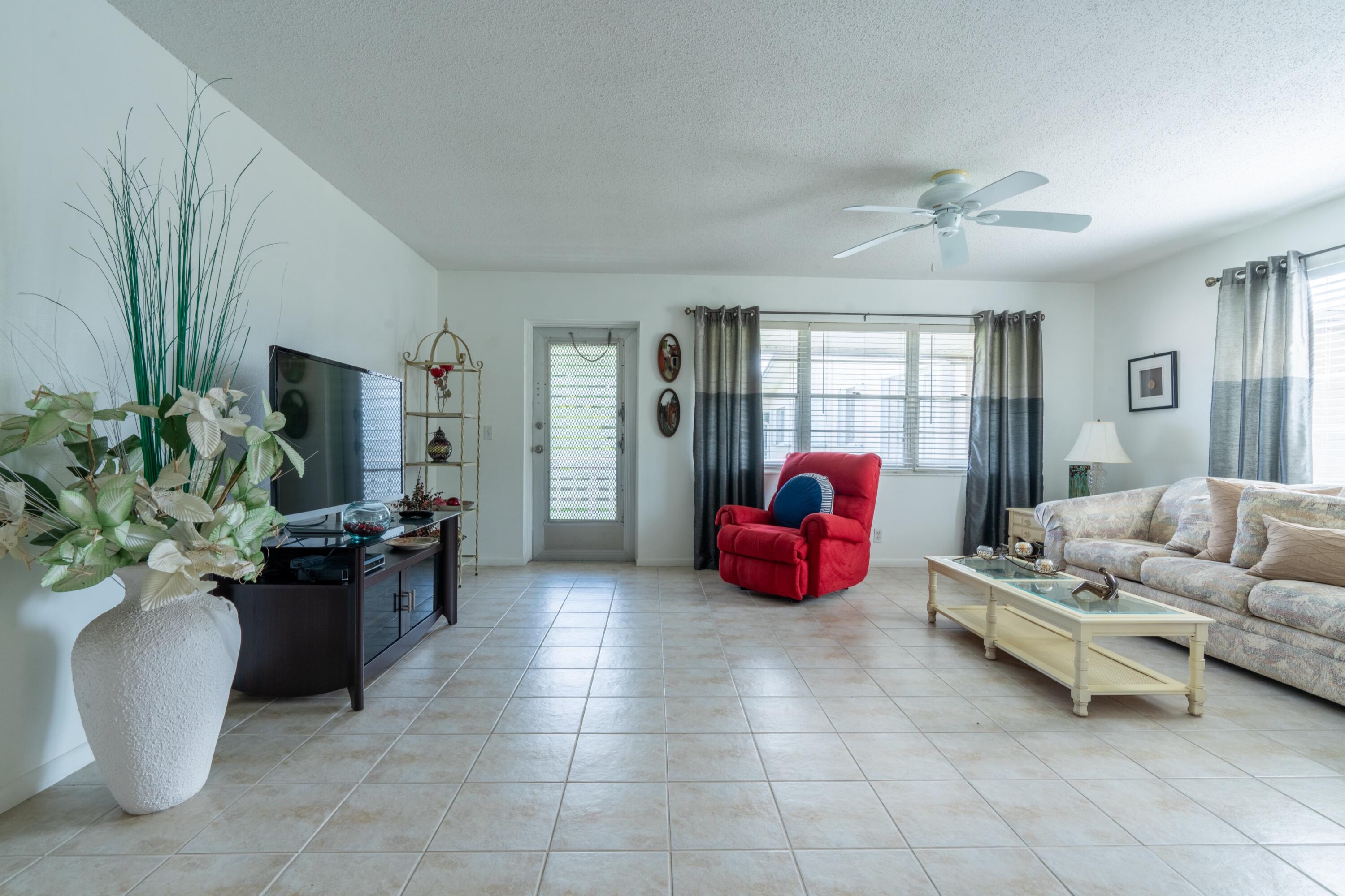 a living room with furniture fireplace and a potted plant