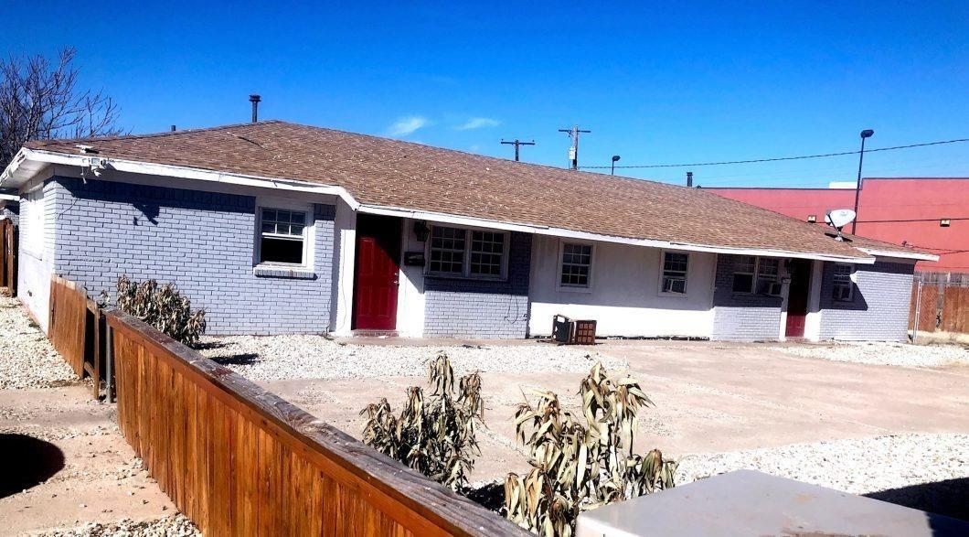 a view of a house with wooden fence