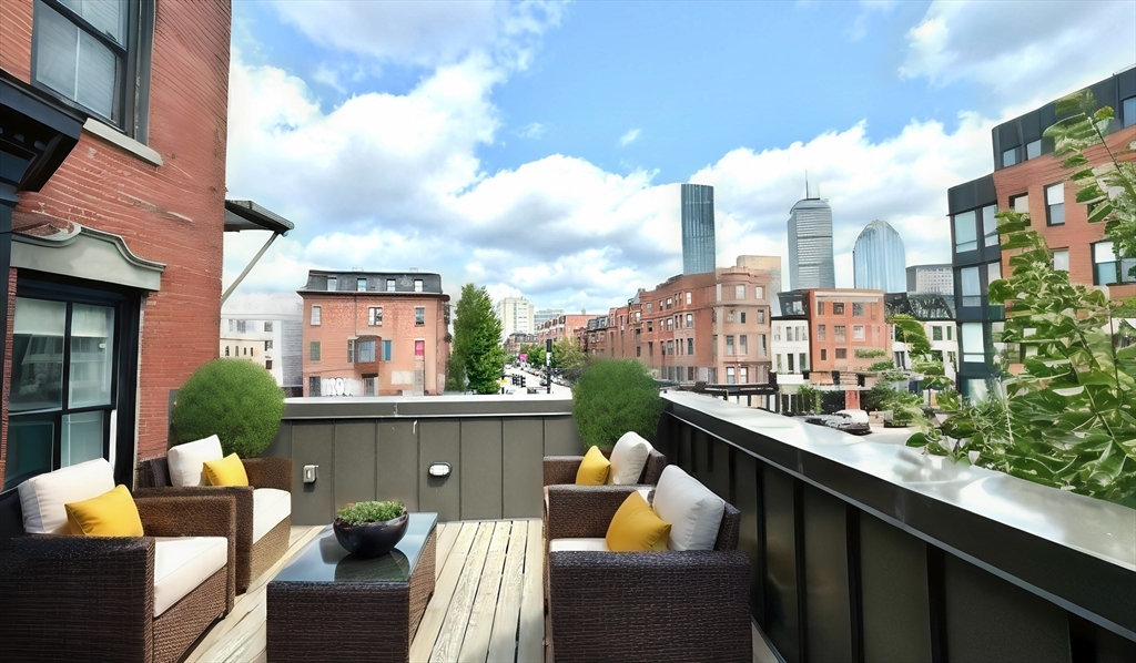 a view of city from balcony with seating space