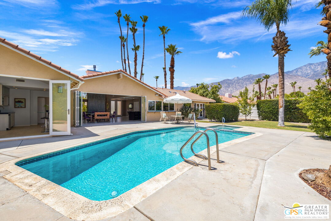 a house view with a swimming pool and a patio