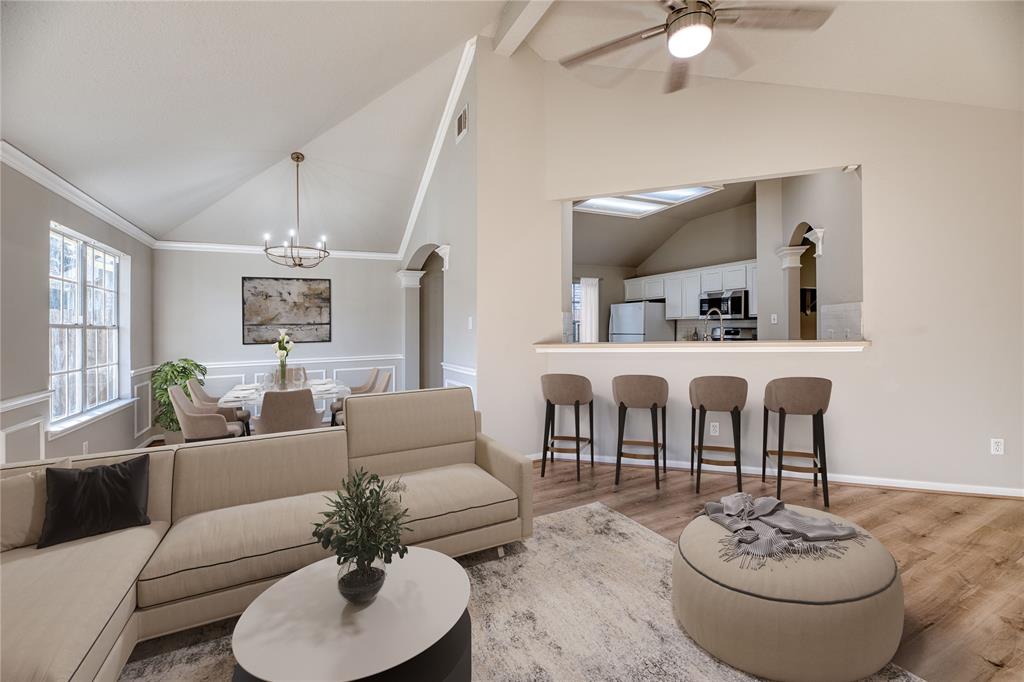 a living room with furniture and a dining table