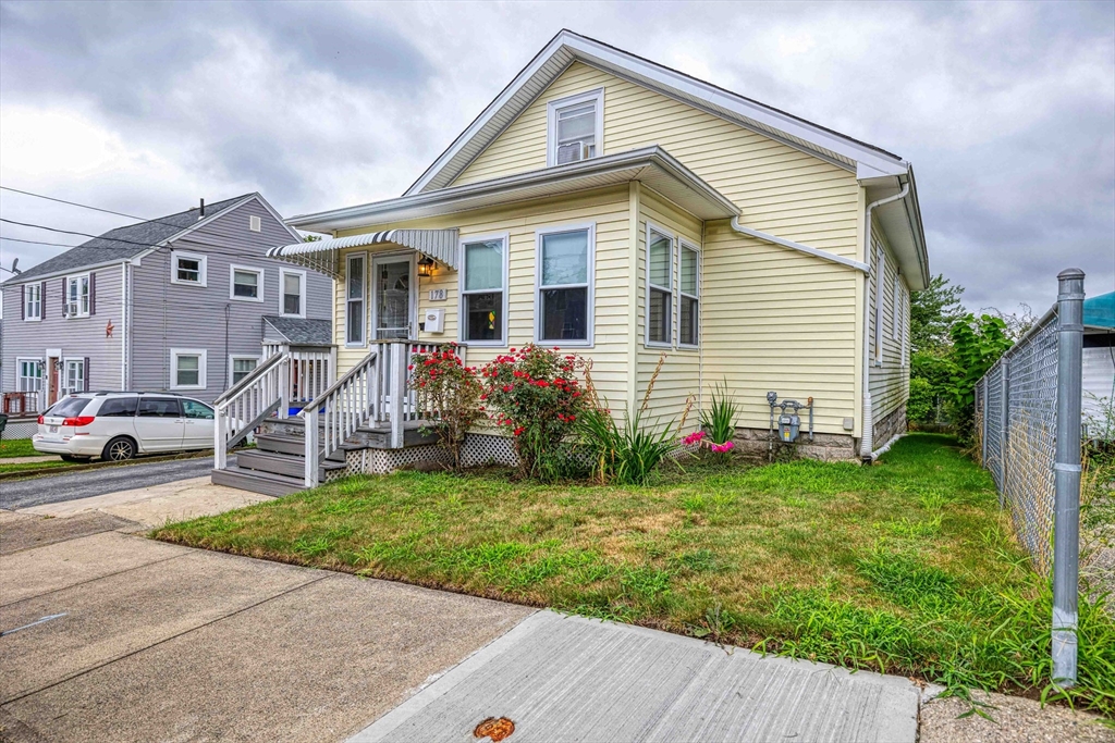 a front view of house with yard and green space