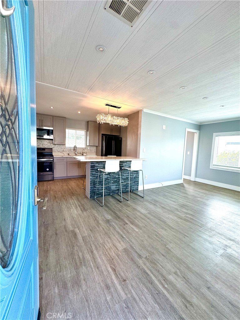 a view of kitchen with furniture and wooden floor