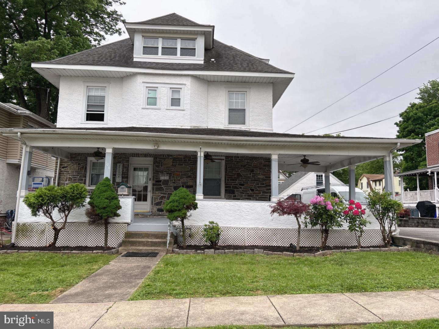 a front view of a house with a garden and plants