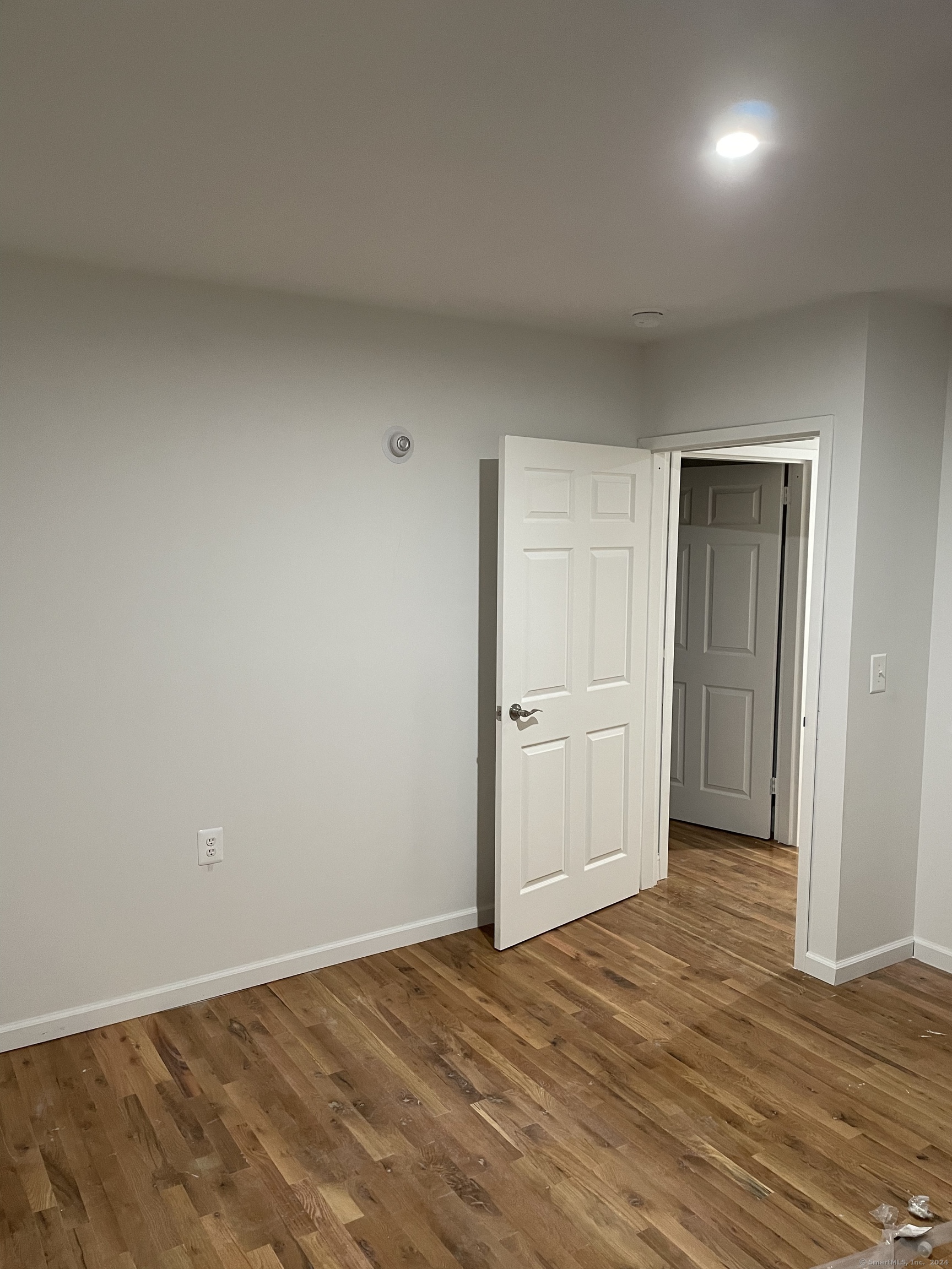 a view of an empty room and wooden floor