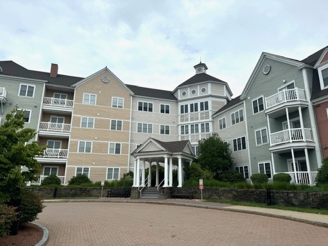 a front view of a building with a yard