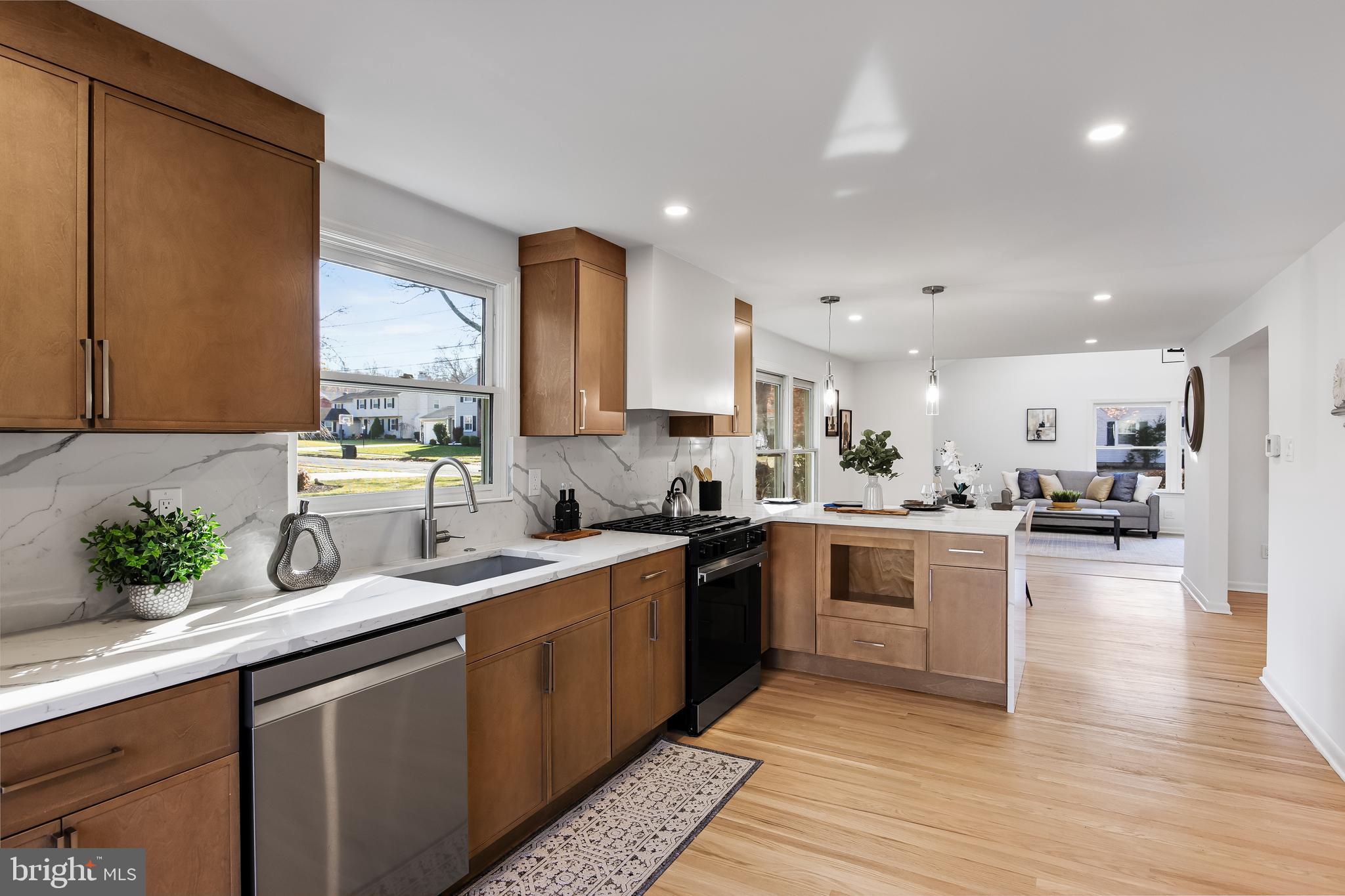 a kitchen with a sink stainless steel appliances and cabinets