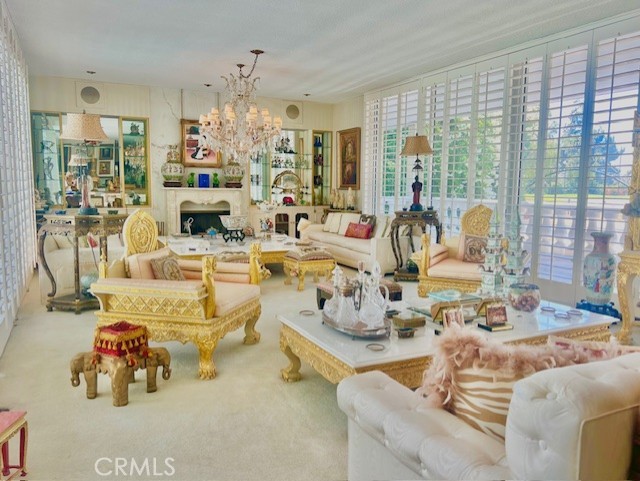 Living room with golf course and pool views.