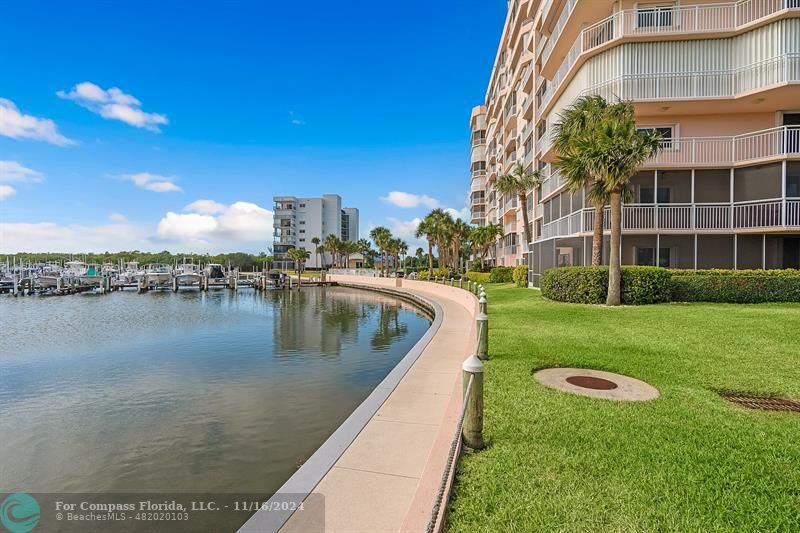 a view of a lake with a building and a yard