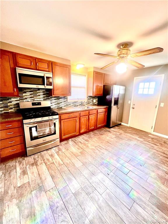 a large kitchen with stainless steel appliances granite countertop a stove and a sink