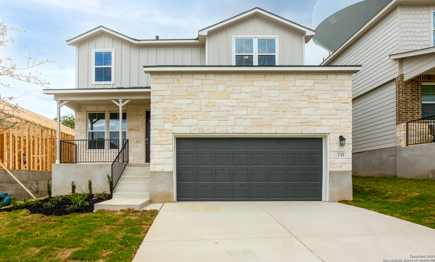 a front view of a house with a yard and garage