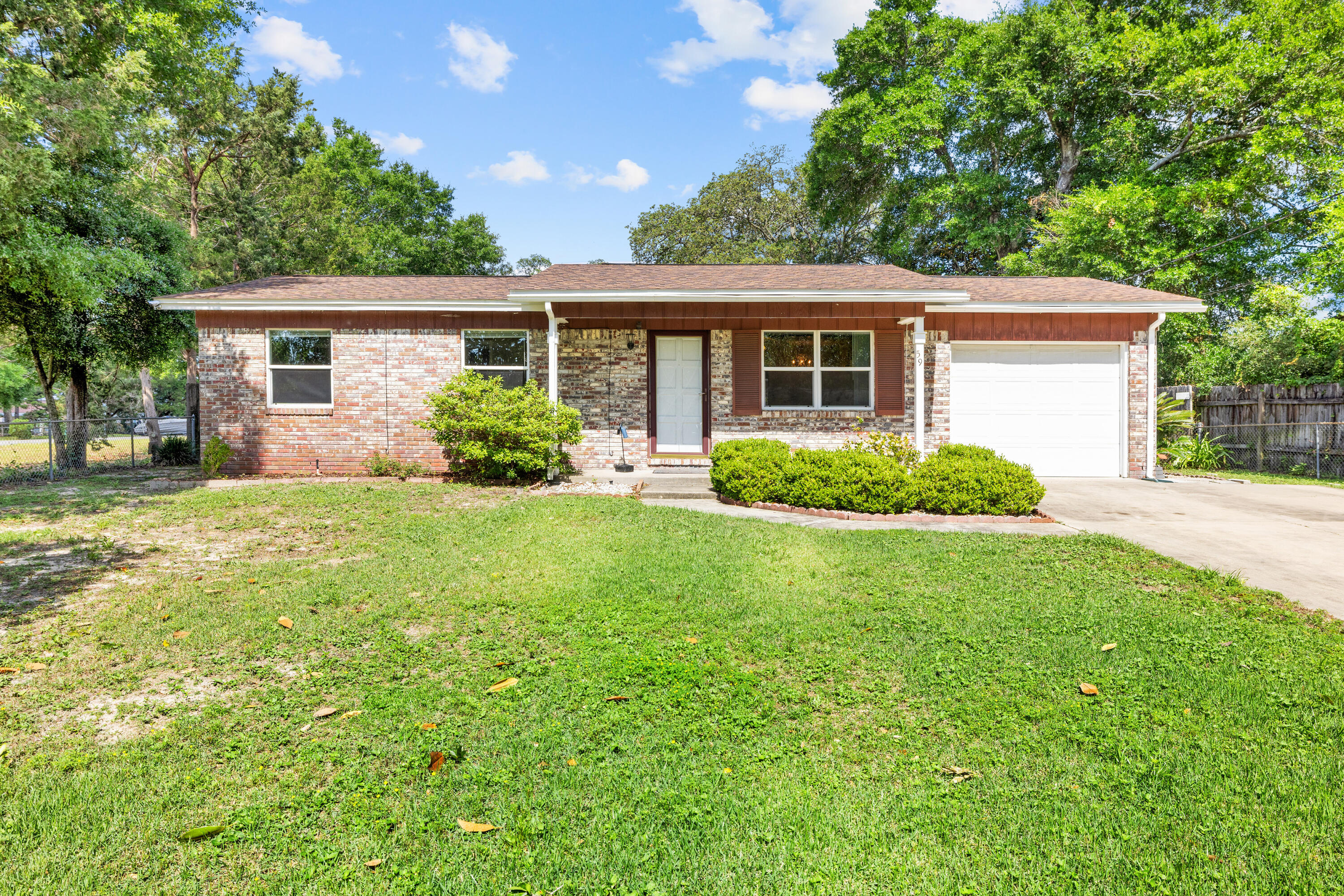 a front view of house with yard and green space