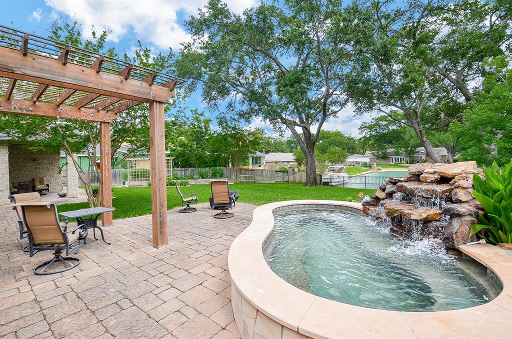 a view of a backyard with sitting area