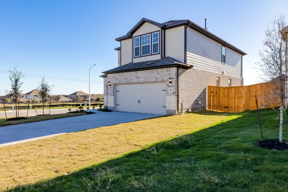 a view of a house with backyard and sitting area