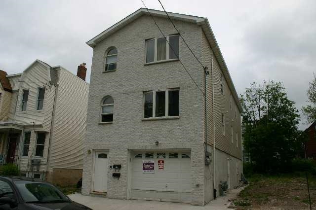 a front view of a house with plants